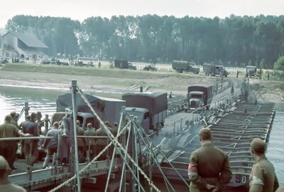 German trucks cross a pontoon bridge at Senlis France, approximately 20 miles from Paris..jpg